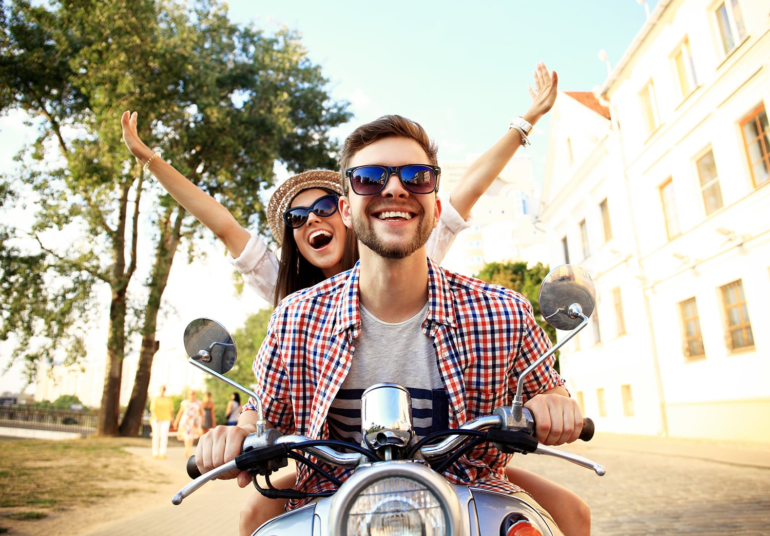 Portrait of happy young couple on scooter enjoying road trip Portrait of happy young couple on scooter enjoying road trip