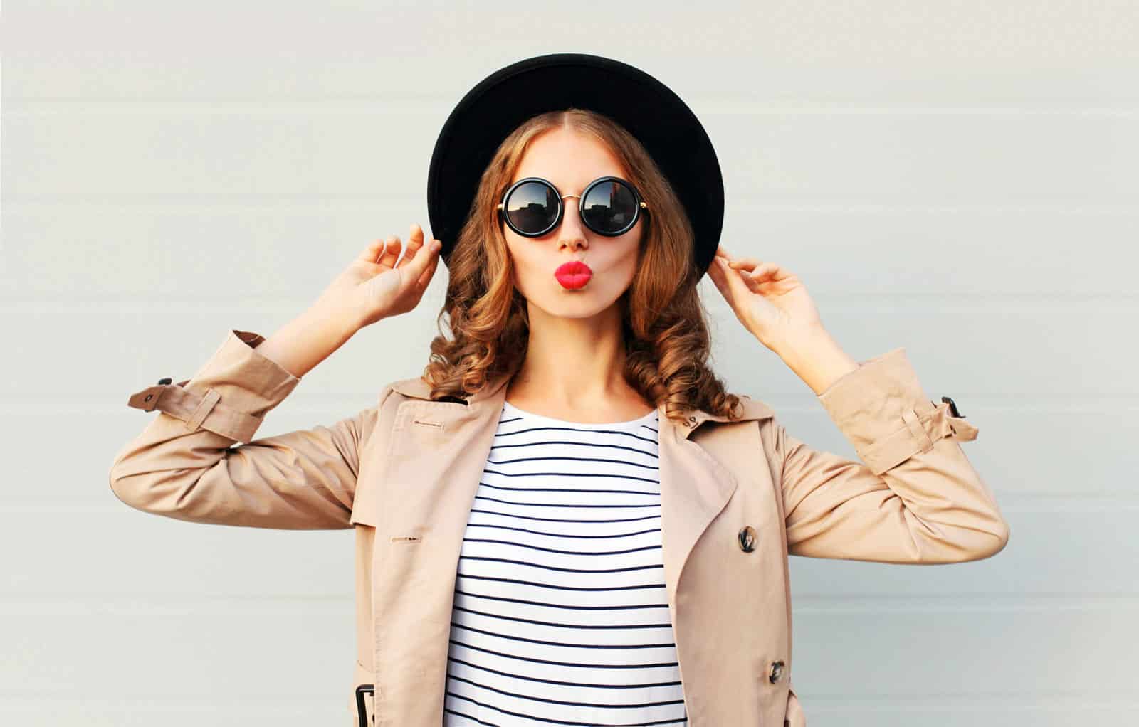 Fashion portrait pretty sweet woman blowing red lips, black hat Fashion portrait pretty sweet woman blowing red lips, black hat